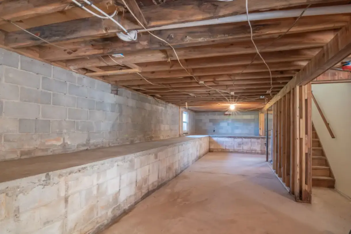 Below-grade wall and joist bays before framing and board