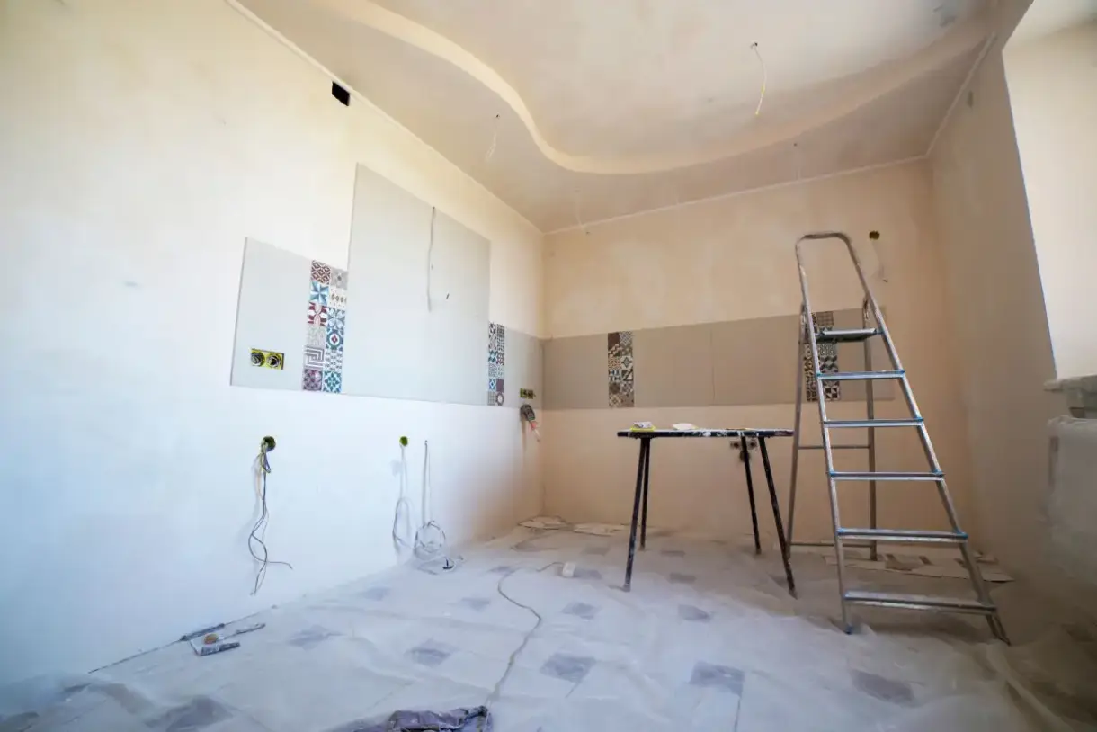Room set up for ceiling drywall repair with tools and materials in place