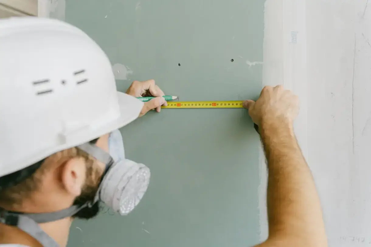 Finished drywall surface measured and checked before handover