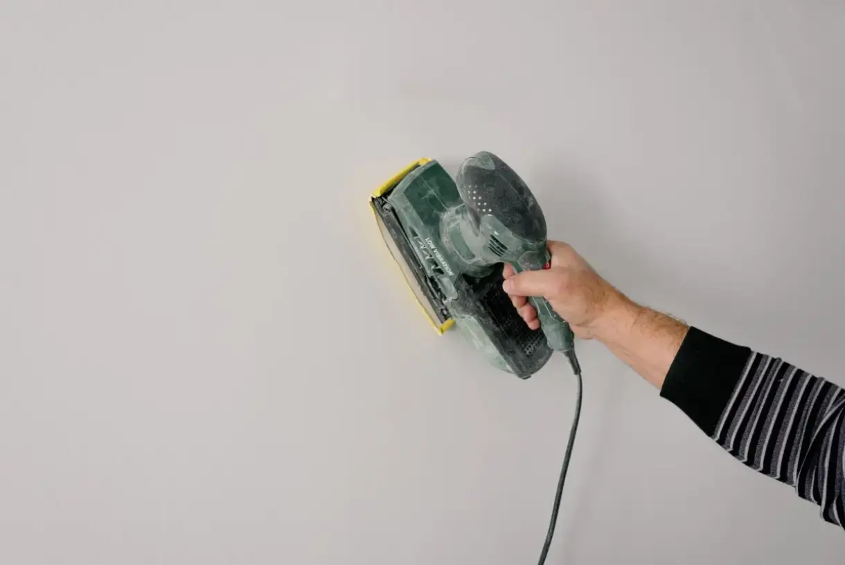 Joint compound smoothed across a drywall seam during finishing