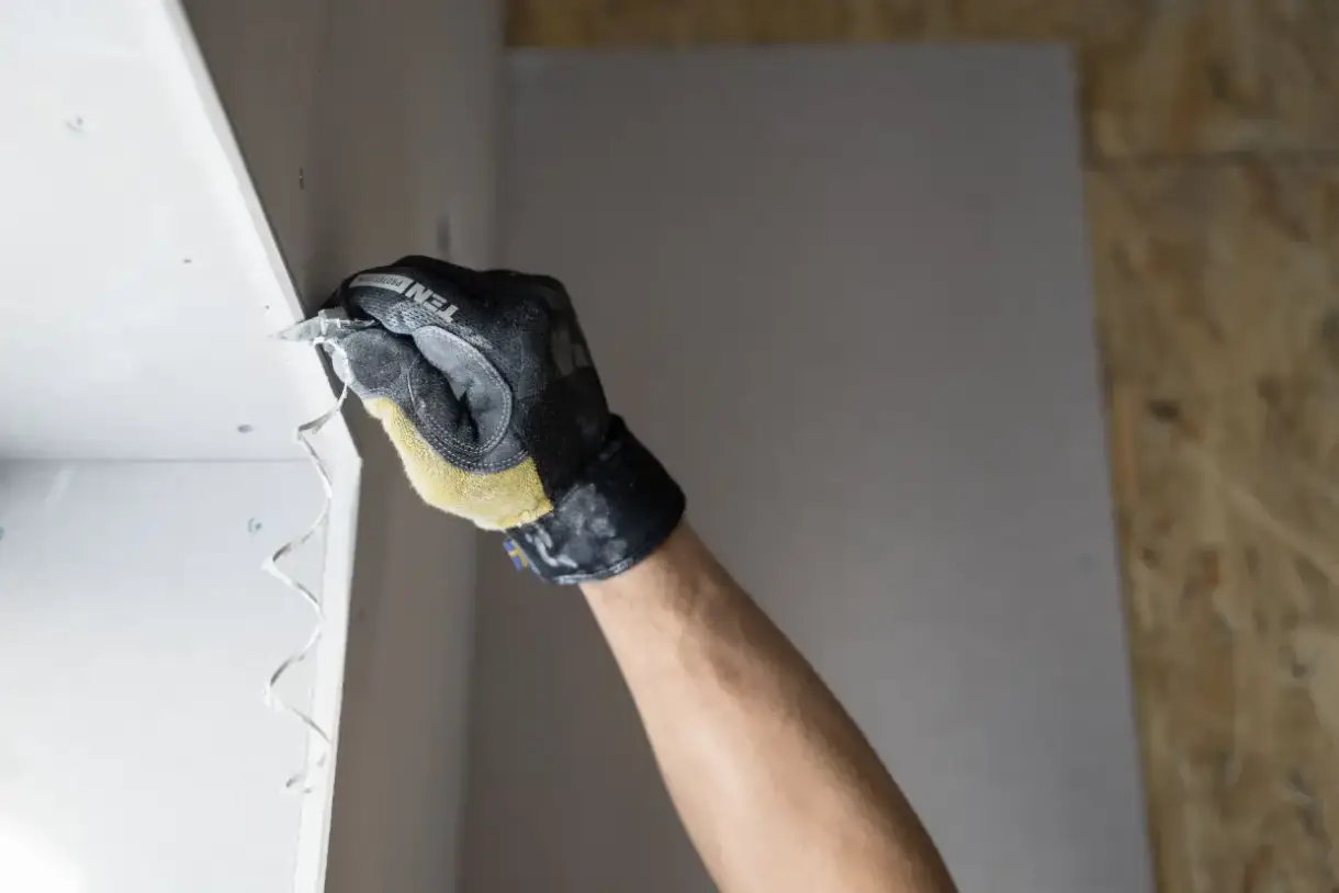 Joint compound applied over a drywall patch with a taping knife