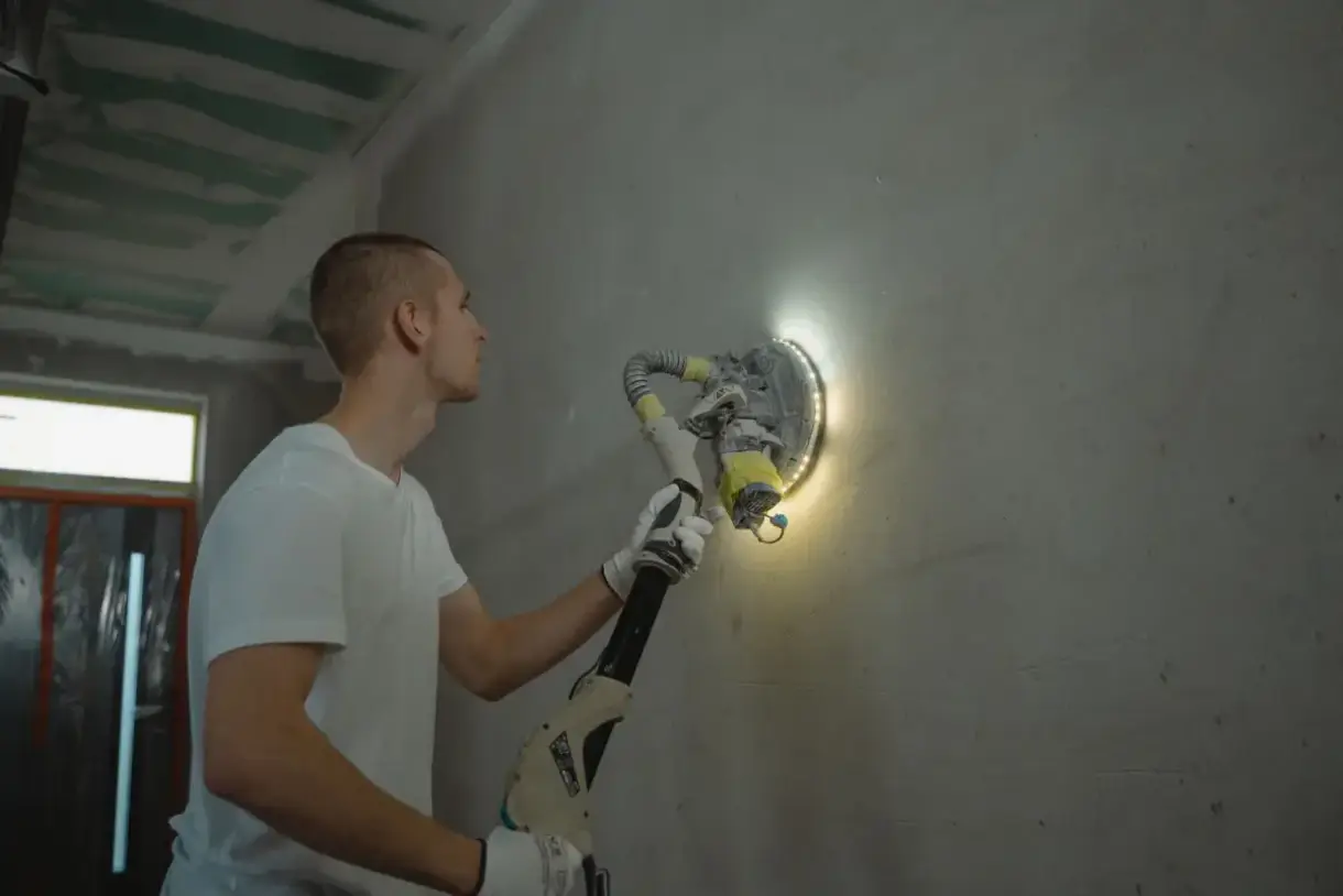 Repaired section of drywall sanded flush with the surrounding wall