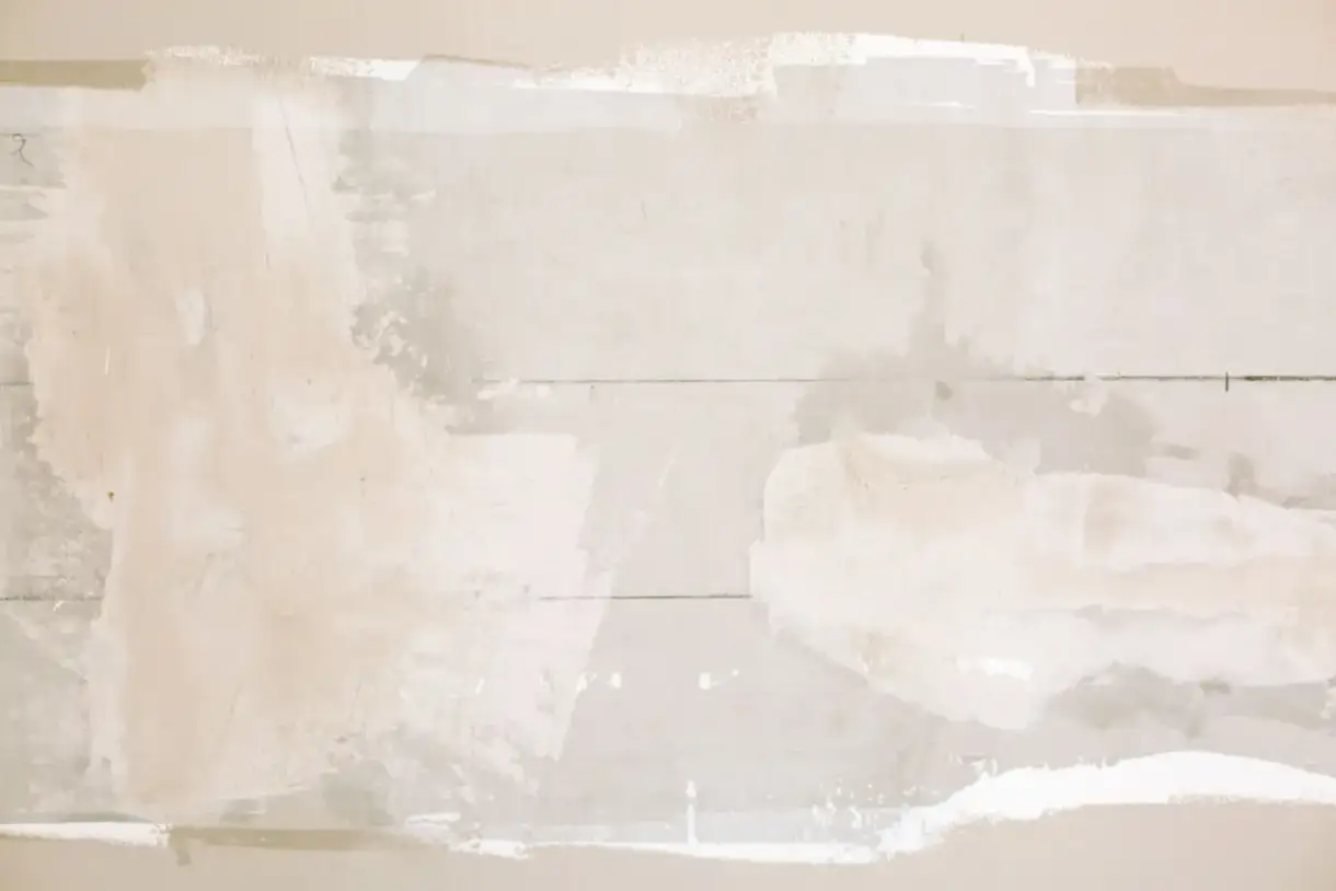 Drywall patch in place before the surrounding texture is matched