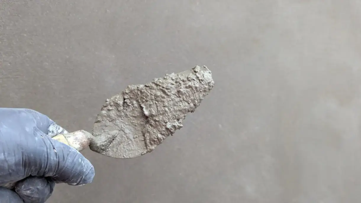 Plaster smoothed across a wall with a finishing trowel